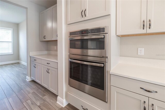 4861 Antrim Dr, Sarasota, FL 34240 - kitchen featuring double oven, light countertops, and light wood-style floors