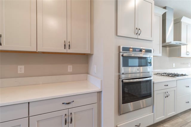 4861 Antrim Dr, Sarasota, FL 34240 - kitchen with stainless steel appliances, wall chimney exhaust hood, and light countertops