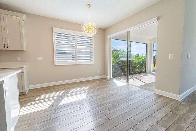 4861 Antrim Dr, Sarasota, FL 34240 - unfurnished dining area featuring healthy amount of natural light, light wood-style flooring, and a chandelier