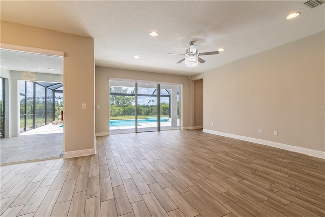 4861 Antrim Dr, Sarasota, FL 34240 - empty room featuring a ceiling fan, wood finished floors, recessed lighting, and a textured ceiling