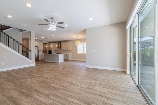 4861 Antrim Dr, Sarasota, FL 34240 - unfurnished living room with ceiling fan, light wood finished floors, stairs, and recessed lighting