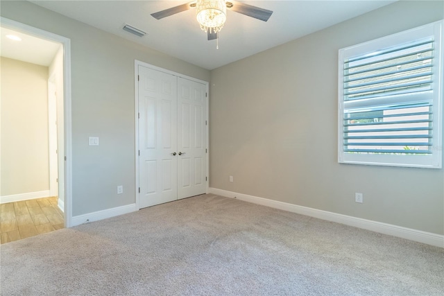 4861 Antrim Dr, Sarasota, FL 34240 - unfurnished bedroom featuring carpet flooring, a closet, and a ceiling fan