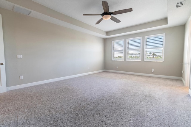 4861 Antrim Dr, Sarasota, FL 34240 - unfurnished room featuring a ceiling fan, light colored carpet, and a tray ceiling