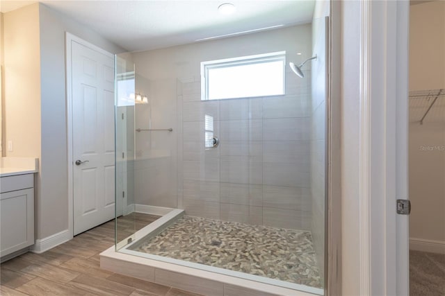4861 Antrim Dr, Sarasota, FL 34240 - full bathroom with a stall shower, vanity, wood finished floors, and a walk in closet
