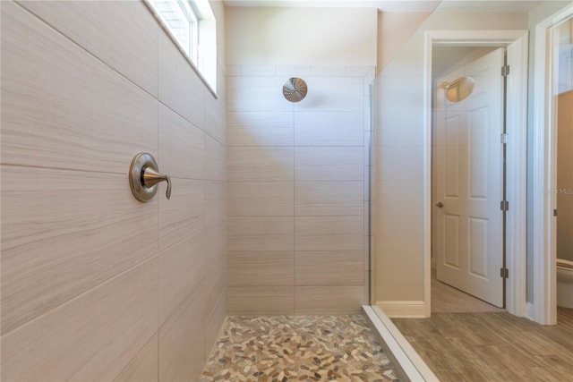 4861 Antrim Dr, Sarasota, FL 34240 - bathroom featuring a tile shower and wood finished floors