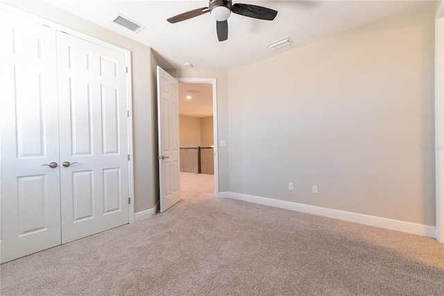 4861 Antrim Dr, Sarasota, FL 34240 - unfurnished bedroom with light carpet, a closet, and a ceiling fan