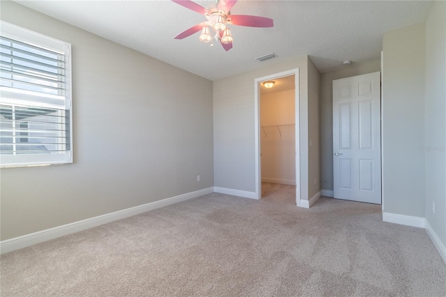 4861 Antrim Dr, Sarasota, FL 34240 - unfurnished bedroom featuring light colored carpet, a spacious closet, a closet, and a textured ceiling