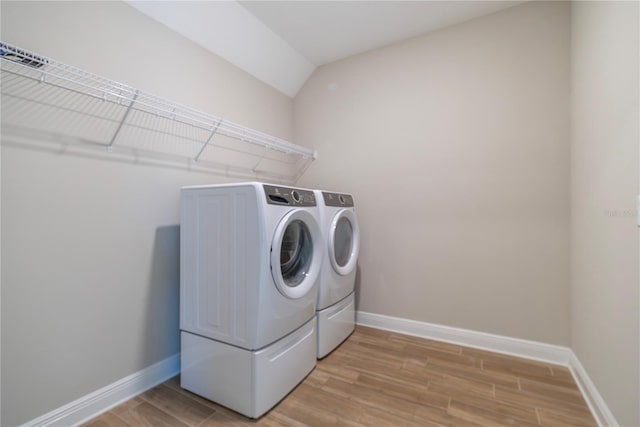 4861 Antrim Dr, Sarasota, FL 34240 - laundry area with washer and dryer and light wood-type flooring