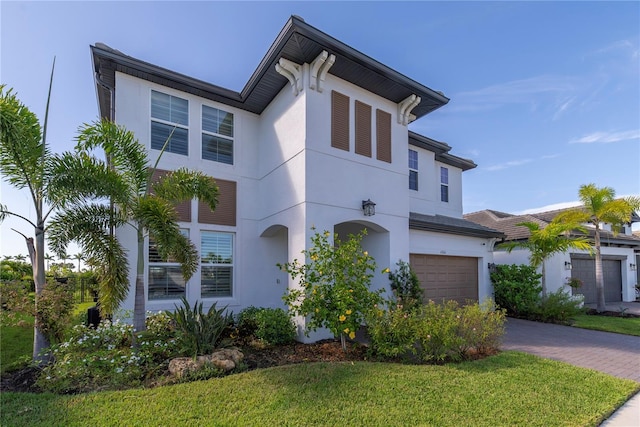 4861 Antrim Dr, Sarasota, FL 34240 - view of front facade with stucco siding, driveway, a garage, and a front yard