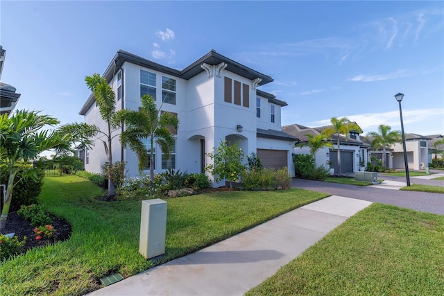 4861 Antrim Dr, Sarasota, FL 34240 - view of front facade featuring asphalt driveway, a front lawn, stucco siding, and a garage