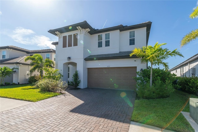 4861 Antrim Dr, Sarasota, FL 34240 - view of front facade featuring stucco siding, an attached garage, and decorative driveway