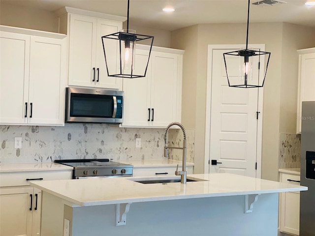 16454 Silver Brook Way, Winter Garden, FL 34787 - kitchen featuring stainless steel appliances, a sink, decorative backsplash, a center island with sink, and white cabinets