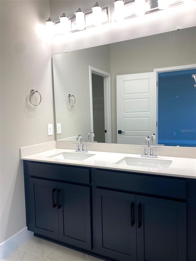 16454 Silver Brook Way, Winter Garden, FL 34787 - full bathroom with double vanity, baseboards, and marble look tile flooring