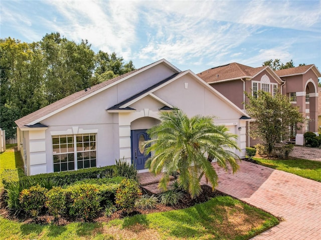 879 Nonastone Run, Casselberry, FL 32707 - view of front facade with decorative driveway, stucco siding, and an attached garage