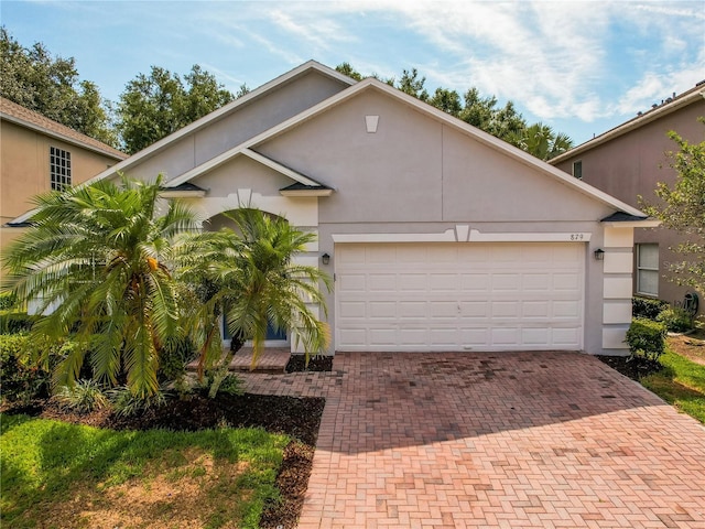 879 Nonastone Run, Casselberry, FL 32707 - view of front of property featuring decorative driveway, stucco siding, and an attached garage