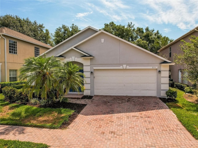 879 Nonastone Run, Casselberry, FL 32707 - view of front facade with decorative driveway, stucco siding, and a garage