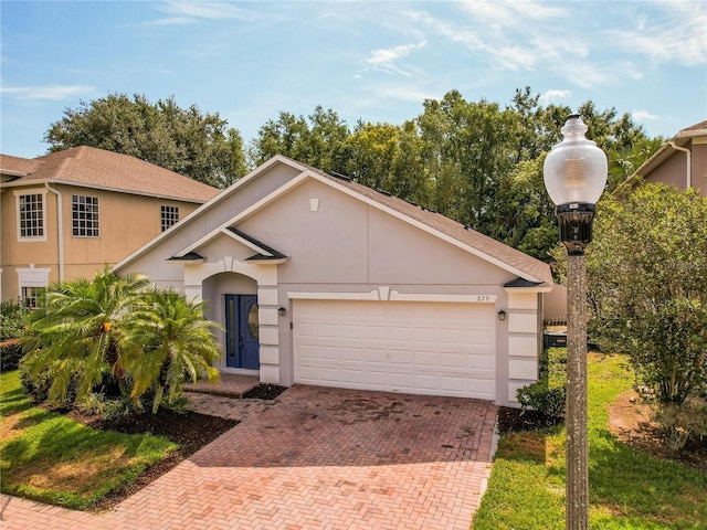 879 Nonastone Run, Casselberry, FL 32707 - view of front of home featuring decorative driveway, stucco siding, and an attached garage
