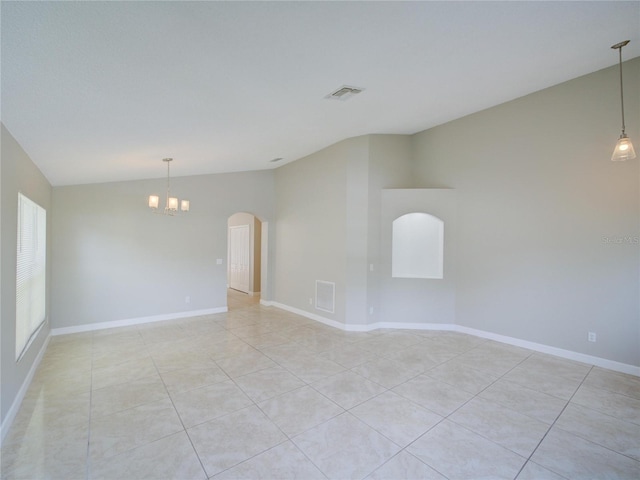 879 Nonastone Run, Casselberry, FL 32707 - spare room with vaulted ceiling, a chandelier, light tile patterned flooring, arched walkways, and baseboards