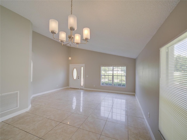 879 Nonastone Run, Casselberry, FL 32707 - spare room featuring lofted ceiling, a chandelier, light tile patterned flooring, and baseboards