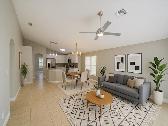 879 Nonastone Run, Casselberry, FL 32707 - living area with arched walkways, vaulted ceiling, ceiling fan, light tile patterned flooring, and baseboards
