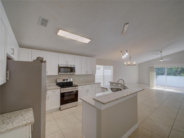 879 Nonastone Run, Casselberry, FL 32707 - kitchen with stainless steel appliances, a sink, light tile patterned flooring, white cabinetry, and an island with sink