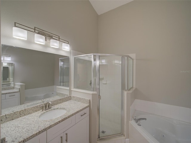 879 Nonastone Run, Casselberry, FL 32707 - bathroom featuring vanity, a stall shower, a whirlpool tub, and vaulted ceiling