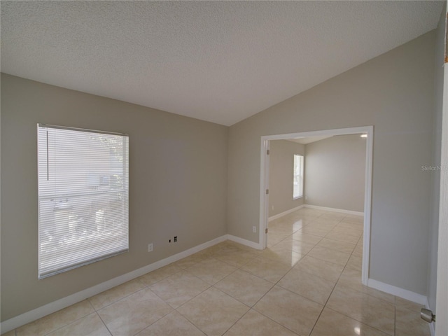 879 Nonastone Run, Casselberry, FL 32707 - empty room with lofted ceiling, light tile patterned floors, a textured ceiling, and baseboards