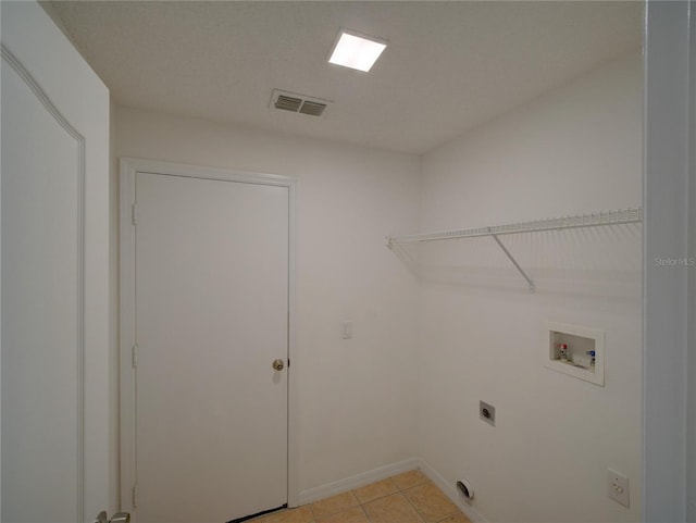 879 Nonastone Run, Casselberry, FL 32707 - laundry room featuring electric dryer hookup, hookup for a washing machine, light tile patterned floors, and baseboards