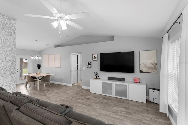 122 Seville Rd, Auburndale, FL 33823 - living area featuring lofted ceiling, a chandelier, wood finished floors, a ceiling fan, and baseboards