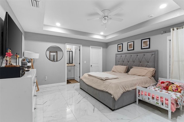 122 Seville Rd, Auburndale, FL 33823 - bedroom with a raised ceiling, recessed lighting, baseboards, light marble finish floors, and ensuite bathroom