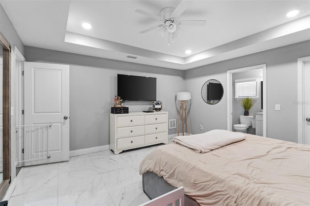 122 Seville Rd, Auburndale, FL 33823 - bedroom featuring recessed lighting, a tray ceiling, light marble finish floors, ensuite bathroom, and a ceiling fan
