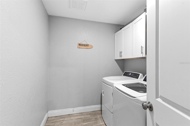 122 Seville Rd, Auburndale, FL 33823 - washroom featuring cabinet space, separate washer and dryer, light wood-style floors, and baseboards