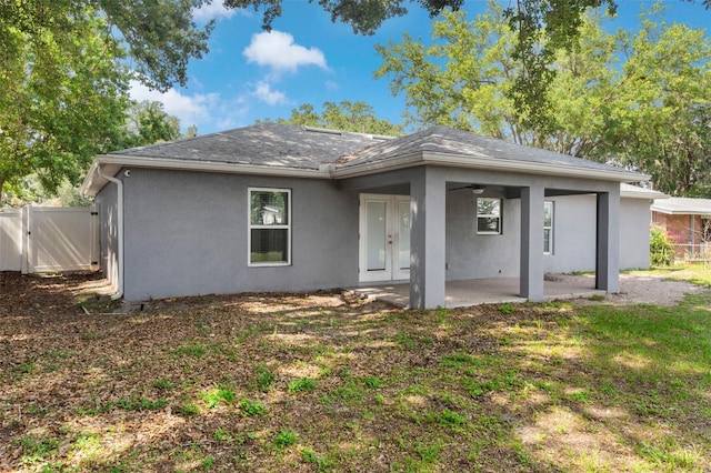 122 Seville Rd, Auburndale, FL 33823 - back of house featuring a patio area, stucco siding, a ceiling fan, and a gate