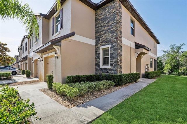 11632 Castine St, New Port Richey, FL 34654 - view of side of property featuring concrete driveway, stucco siding, stone siding, an attached garage, and a yard