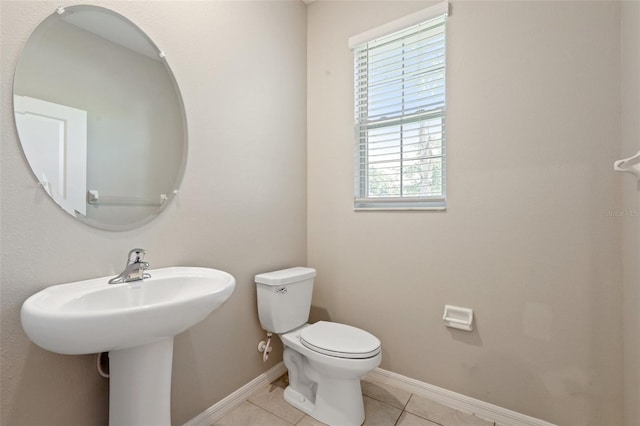 11632 Castine St, New Port Richey, FL 34654 - bathroom featuring tile patterned flooring, toilet, and baseboards