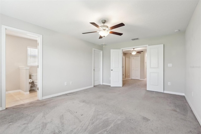 11632 Castine St, New Port Richey, FL 34654 - unfurnished bedroom featuring carpet floors, baseboards, a ceiling fan, and ensuite bath