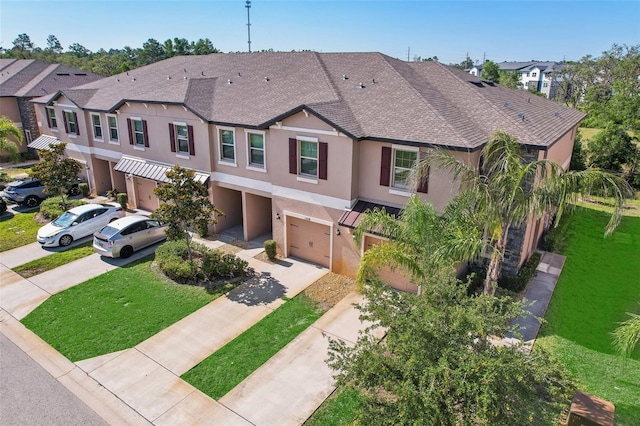 11632 Castine St, New Port Richey, FL 34654 - multi unit property featuring a garage, stucco siding, concrete driveway, a front lawn, and a shingled roof