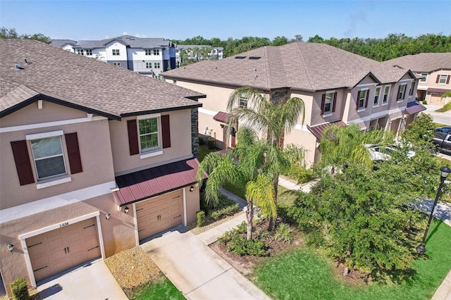 11632 Castine St, New Port Richey, FL 34654 - view of front of house featuring stucco siding, a garage, a shingled roof, concrete driveway, and a residential view
