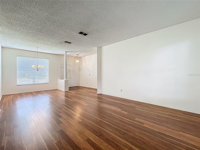 1131 Turtle Lake Ct, Ocoee, FL 34761 - empty room with a chandelier, dark wood-style flooring, and a textured ceiling