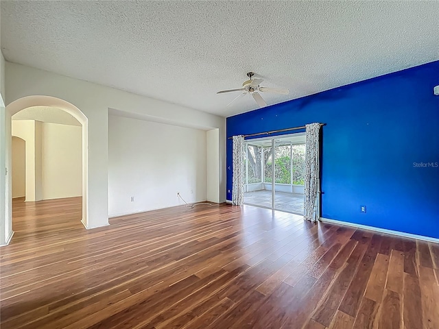 1131 Turtle Lake Ct, Ocoee, FL 34761 - spare room with ceiling fan, wood finished floors, a textured ceiling, and arched walkways