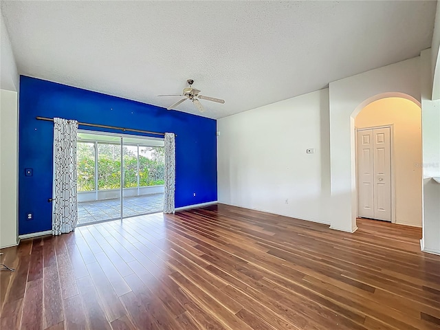 1131 Turtle Lake Ct, Ocoee, FL 34761 - empty room with arched walkways, a ceiling fan, wood finished floors, and a textured ceiling