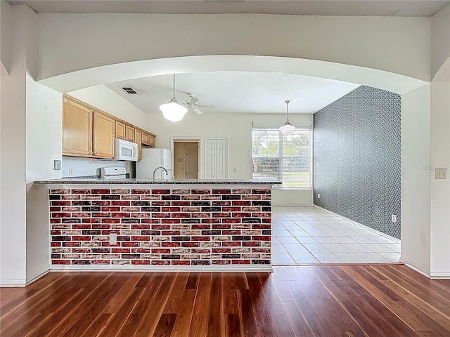 1131 Turtle Lake Ct, Ocoee, FL 34761 - kitchen with white appliances, wood finished floors, arched walkways, decorative light fixtures, and a ceiling fan