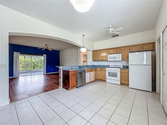 1131 Turtle Lake Ct, Ocoee, FL 34761 - kitchen featuring white appliances, a ceiling fan, open floor plan, and arched walkways