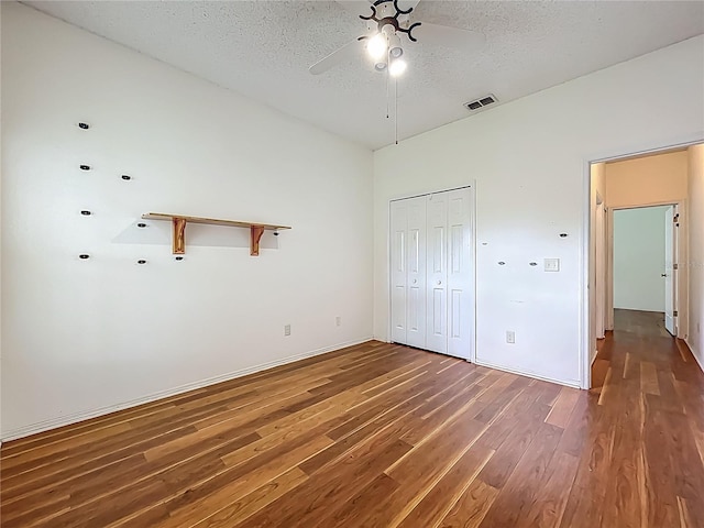 1131 Turtle Lake Ct, Ocoee, FL 34761 - unfurnished bedroom with wood finished floors, a textured ceiling, a closet, a ceiling fan, and baseboards