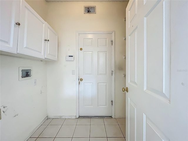 1131 Turtle Lake Ct, Ocoee, FL 34761 - laundry area with hookup for a washing machine, cabinet space, light tile patterned flooring, and baseboards