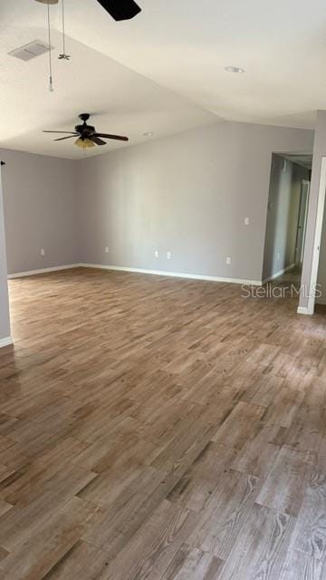 30965 E Thyme Ave, Eustis, FL 32736 - empty room featuring wood finished floors, baseboards, ceiling fan, and vaulted ceiling