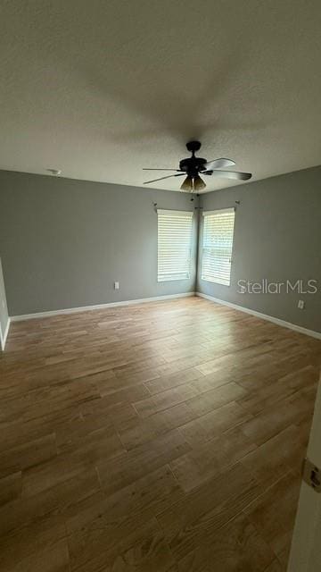 30965 E Thyme Ave, Eustis, FL 32736 - empty room featuring ceiling fan, baseboards, a textured ceiling, and wood finished floors