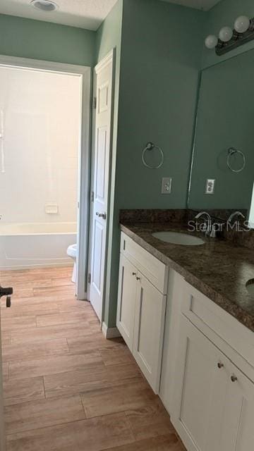 30965 E Thyme Ave, Eustis, FL 32736 - bathroom with double vanity and wood finished floors