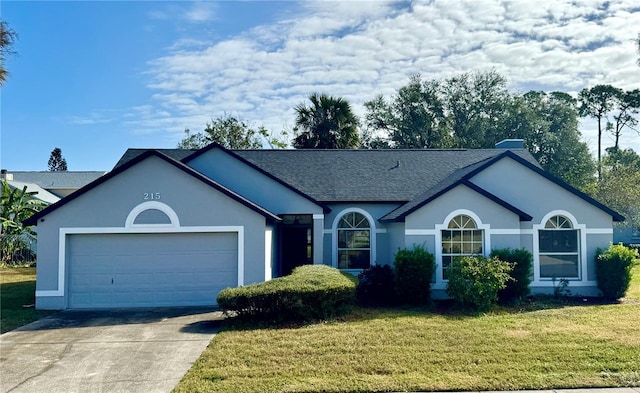 215 Hollowbrook Cir, Daytona Beach, FL 32114 - single story home featuring stucco siding, an attached garage, driveway, a front yard, and roof with shingles