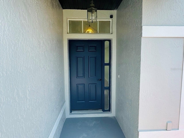 215 Hollowbrook Cir, Daytona Beach, FL 32114 - doorway to property with stucco siding